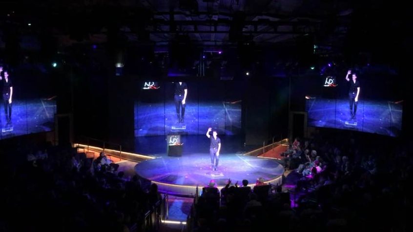 Niels performing on a cruise theater stage